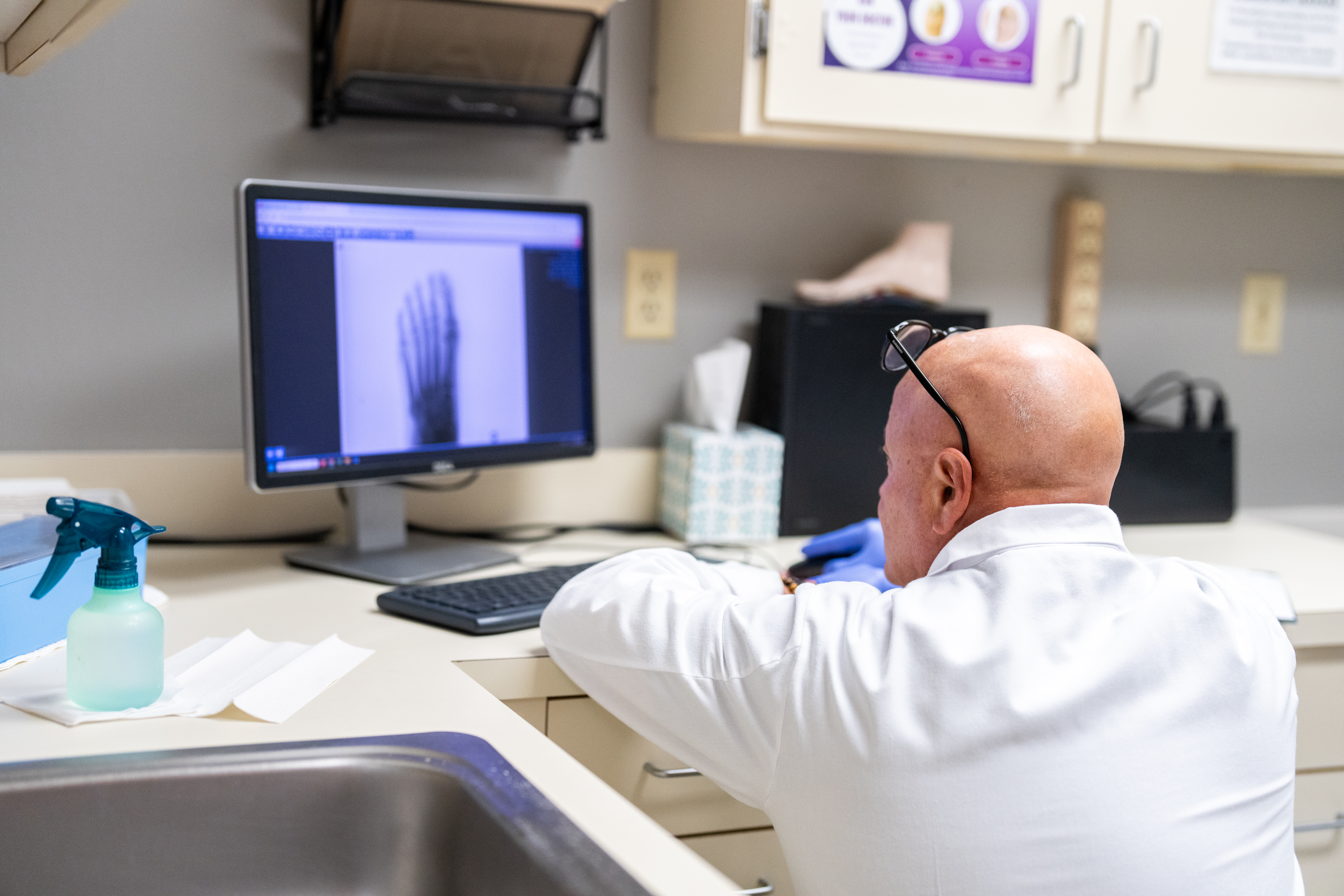 Our CT podiatrist Dr. DeJesus analysing x-ray exam of patient for Tarsal Tunnel Decompression